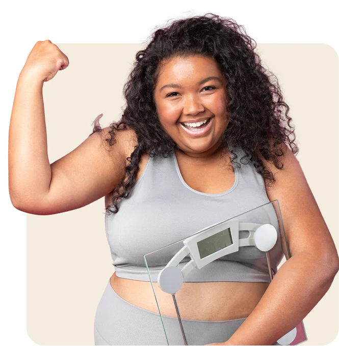 a woman holding a weighing machine.